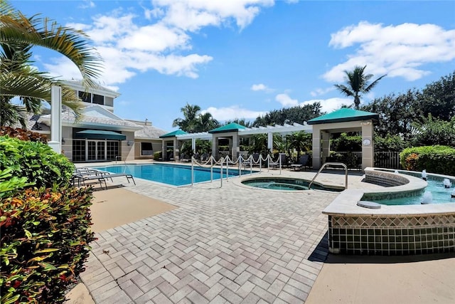community pool featuring a community hot tub, a patio, and fence