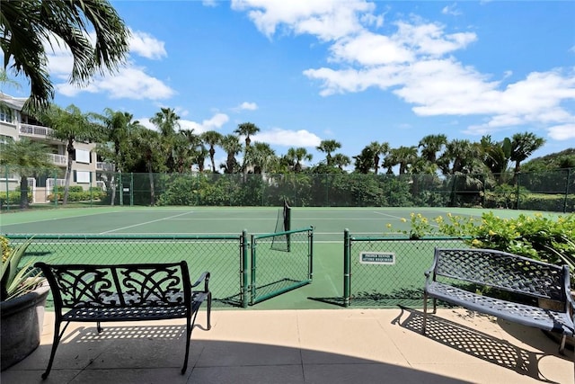view of home's community featuring a tennis court, a gate, and fence