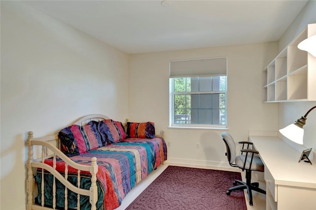 bedroom with a desk and baseboards
