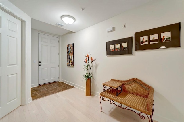 entrance foyer with baseboards and wood finished floors