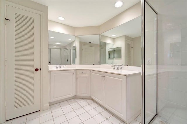 full bathroom featuring a stall shower, a closet, tile patterned floors, recessed lighting, and double vanity