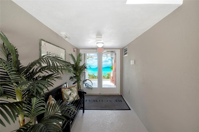 doorway featuring baseboards
