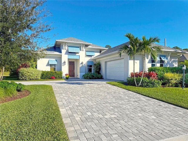 view of front of house featuring a front yard and a garage