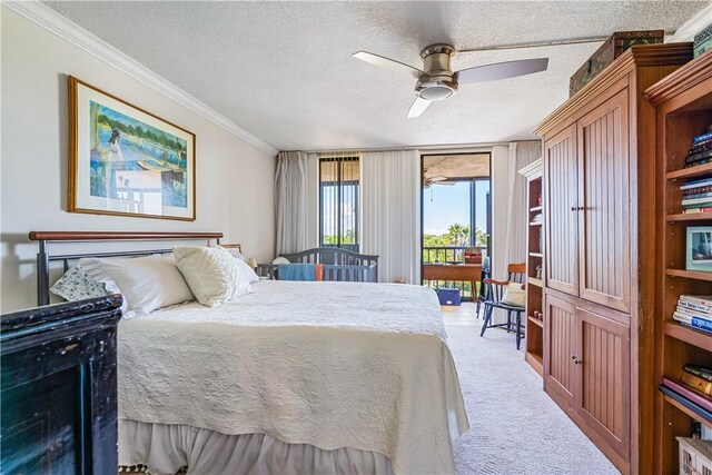 1821 Mooringline Dr Unit 3G, Vero Beach, FL 32963 - bedroom with access to outside, carpet, crown molding, a textured ceiling, and ceiling fan