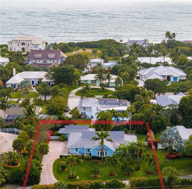 birds eye view of property with a residential view and a water view