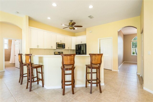 412 N Key Lime Sq SW, Vero Beach, FL 32968 - washroom featuring cabinets, light tile patterned floors, and washing machine and dryer