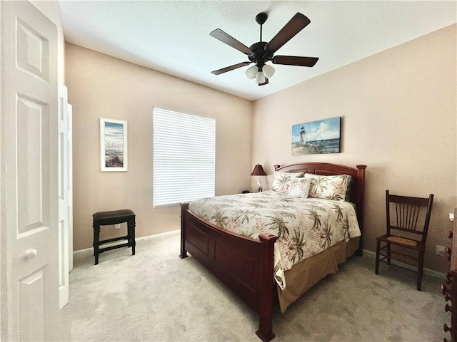 bedroom with ceiling fan and light colored carpet