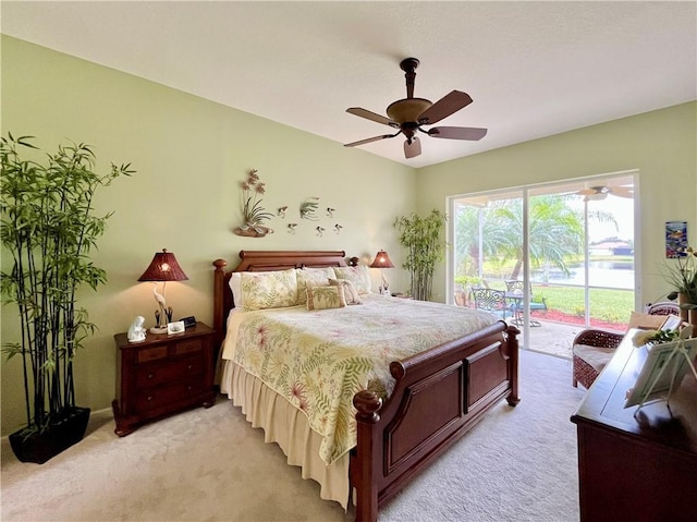 bedroom featuring ceiling fan, light colored carpet, and access to outside