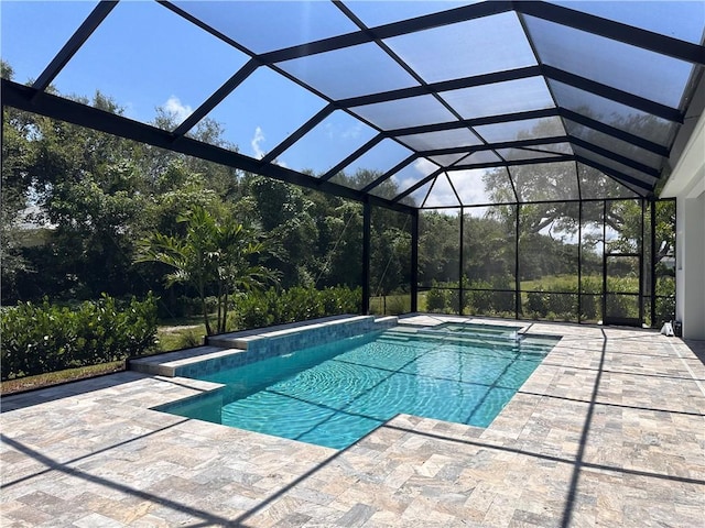 view of swimming pool featuring a lanai and a patio area