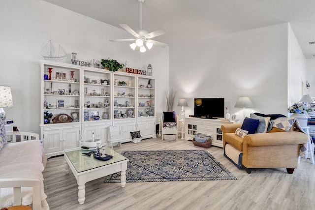 living room featuring ceiling fan and light wood-type flooring