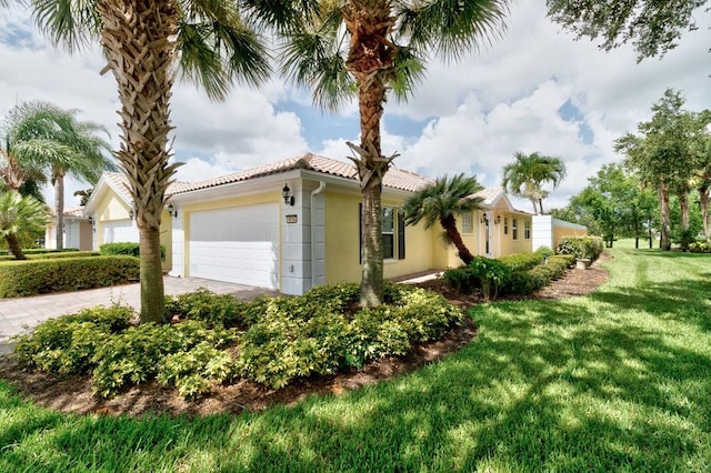 view of side of home with a garage and a lawn