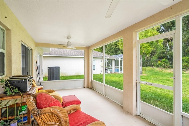 2523 12th Sq SW, Vero Beach, FL 32968 - sunroom featuring a wood stove and a ceiling fan