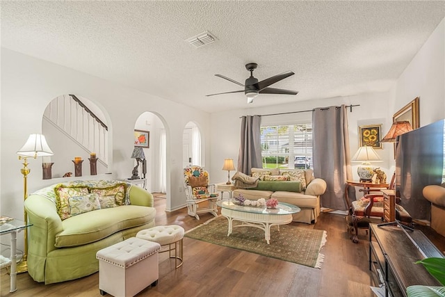 2523 12th Sq SW, Vero Beach, FL 32968 - living area with arched walkways, a textured ceiling, a ceiling fan, wood finished floors, and visible vents