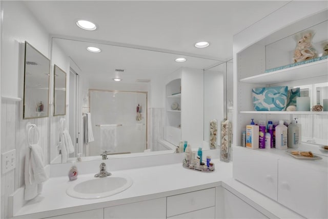 bathroom featuring vanity and an enclosed shower