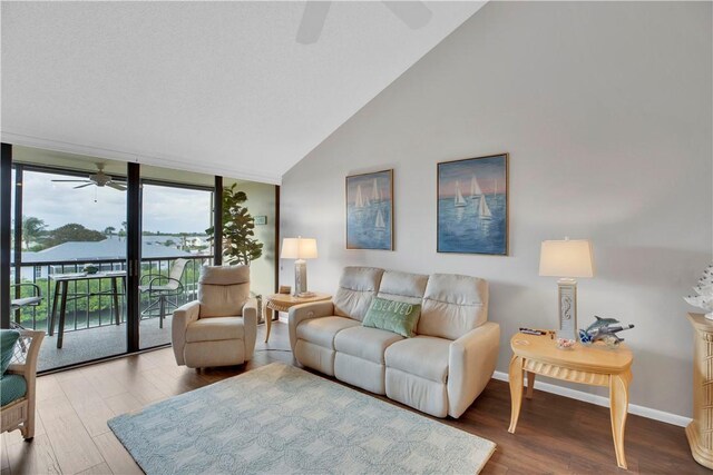 living room with ceiling fan, wood-type flooring, and high vaulted ceiling