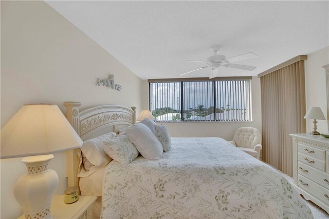 carpeted bedroom featuring floor to ceiling windows, a textured ceiling, access to outside, and ceiling fan