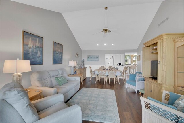 living room featuring ceiling fan, high vaulted ceiling, and dark wood-type flooring