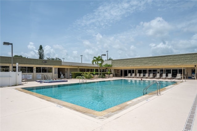 pool with fence and a patio area