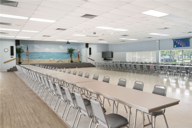 interior space with wood finished floors, a paneled ceiling, and visible vents