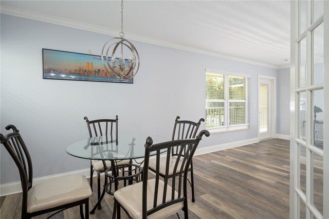 dining area featuring baseboards, a notable chandelier, ornamental molding, and dark wood finished floors