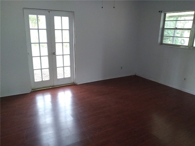 unfurnished room featuring french doors and dark hardwood / wood-style floors