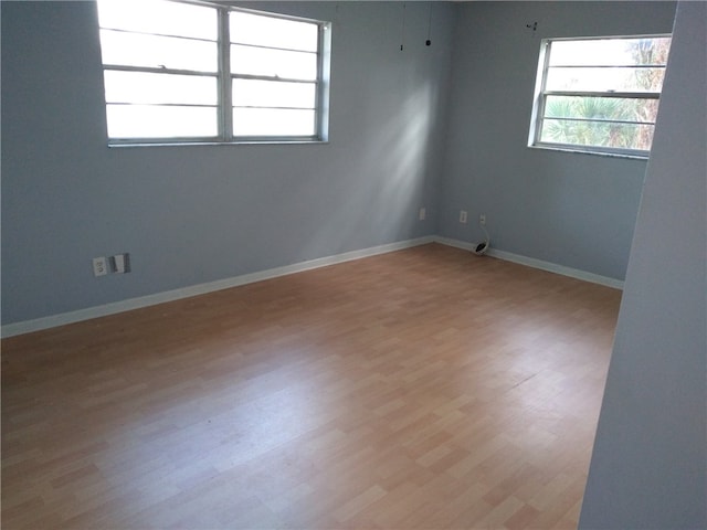 unfurnished room with light wood-type flooring