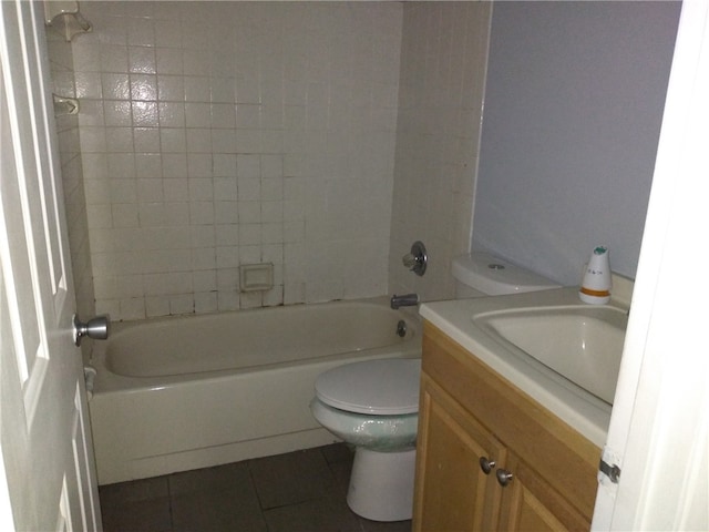 full bathroom featuring tile patterned flooring, vanity, toilet, and tiled shower / bath