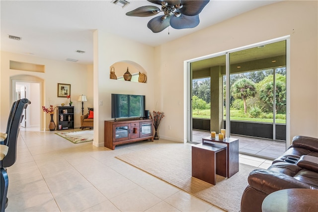 tiled living room with ceiling fan