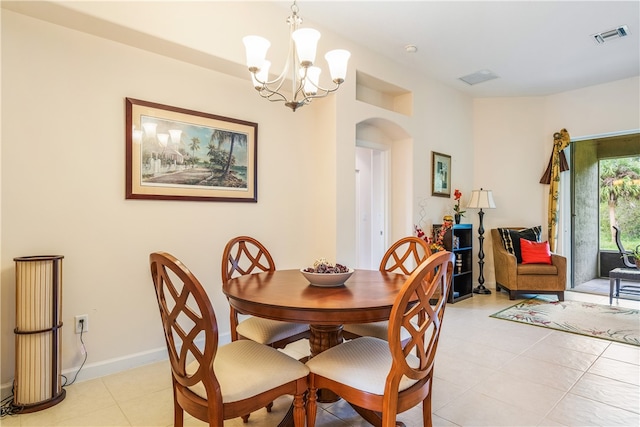 tiled dining area with an inviting chandelier