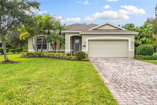 view of front of home featuring a garage and a front yard