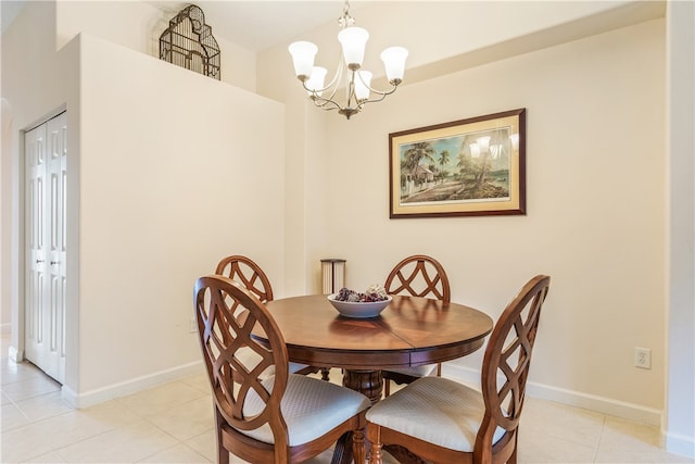 tiled dining area featuring a chandelier