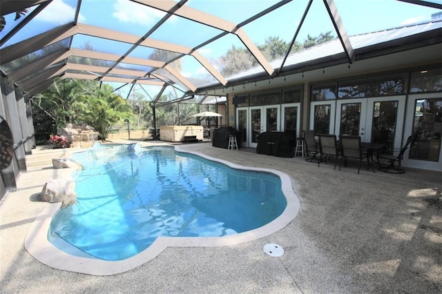 outdoor pool with a patio, french doors, and a lanai