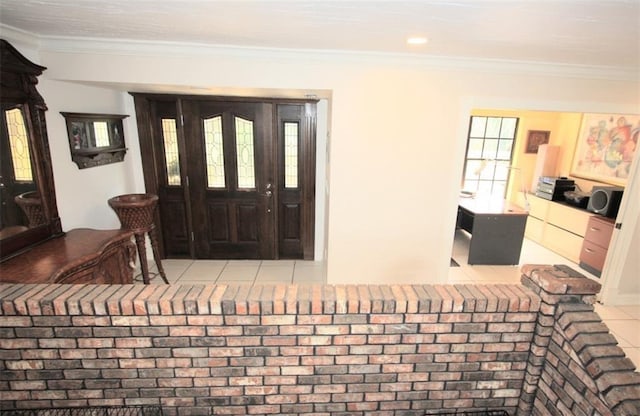 tiled foyer entrance with plenty of natural light and crown molding