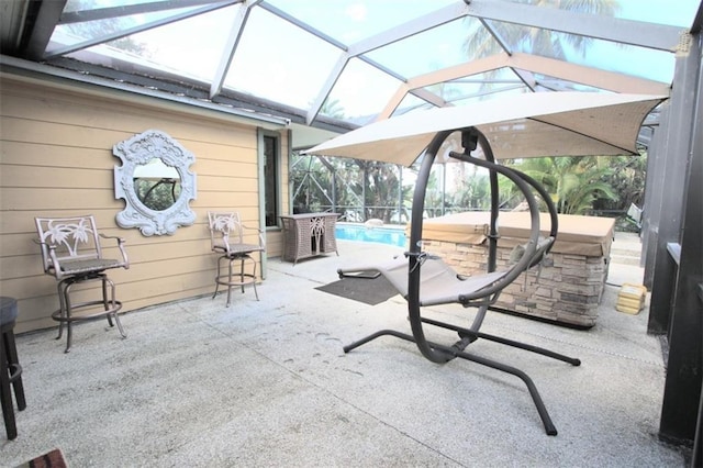 view of patio / terrace featuring glass enclosure and an outdoor pool