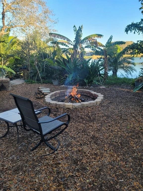 view of yard featuring an outdoor fire pit