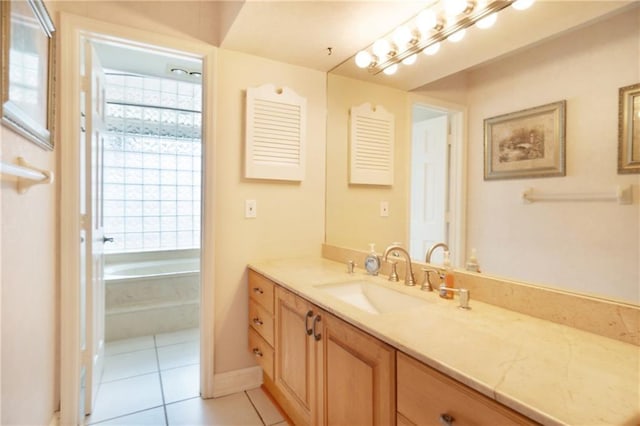 full bathroom featuring a garden tub, tile patterned flooring, and vanity