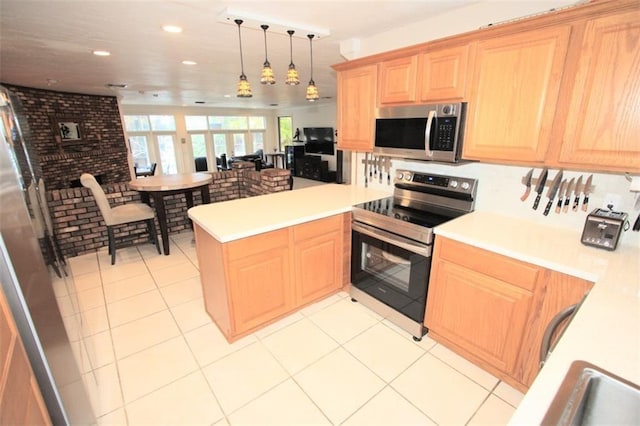 kitchen with light tile patterned floors, a peninsula, light countertops, appliances with stainless steel finishes, and light brown cabinetry