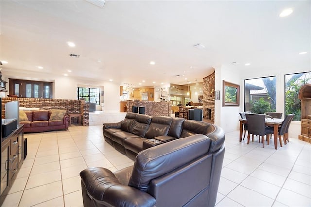 living area with light tile patterned floors, visible vents, and recessed lighting