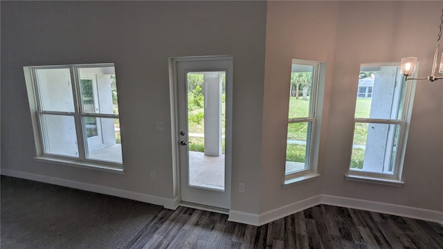 665 Rolling Hill Dr, Sebastian, FL 32958 - entryway featuring dark wood-style flooring, baseboards, and a chandelier