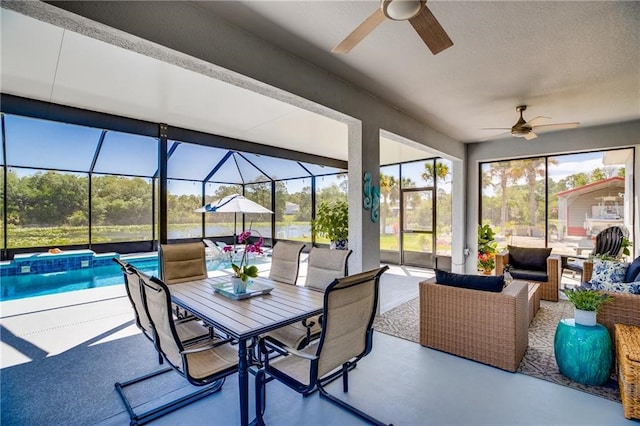 sunroom featuring ceiling fan and a wealth of natural light