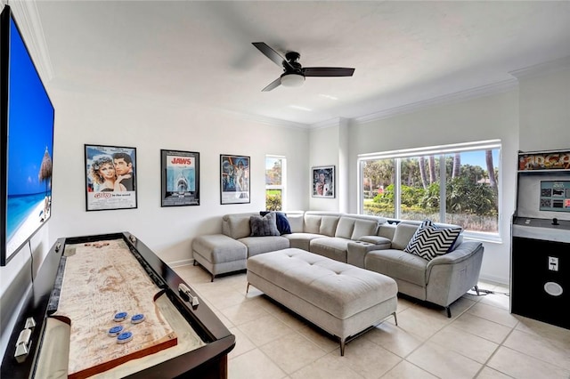 living area with light tile patterned floors, a ceiling fan, and ornamental molding