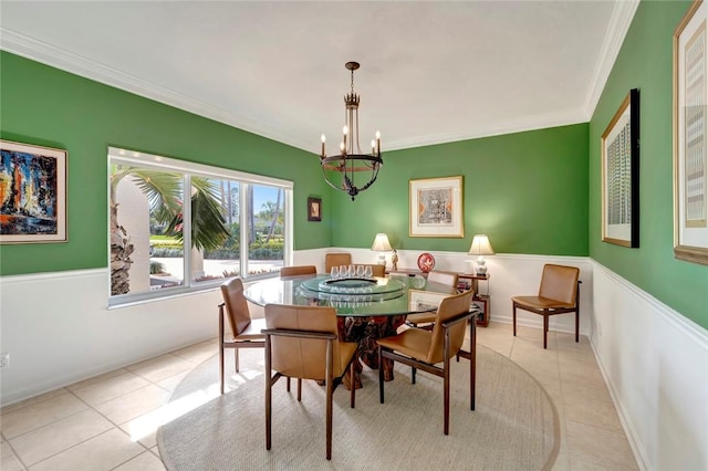 dining area with light tile patterned floors, a chandelier, crown molding, and baseboards