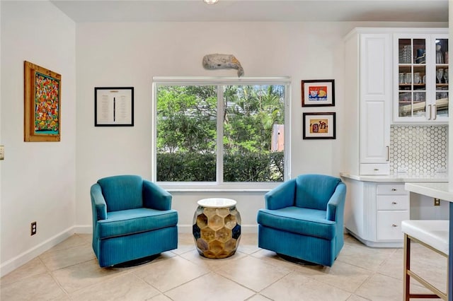 living area with light tile patterned flooring and baseboards