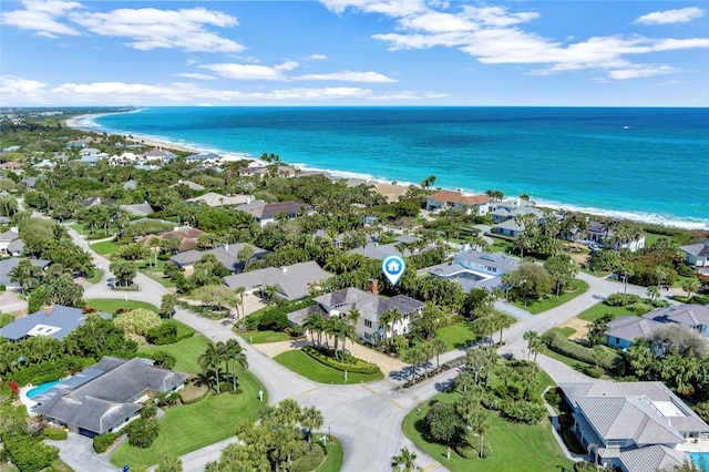 aerial view with a view of the beach, a residential view, and a water view