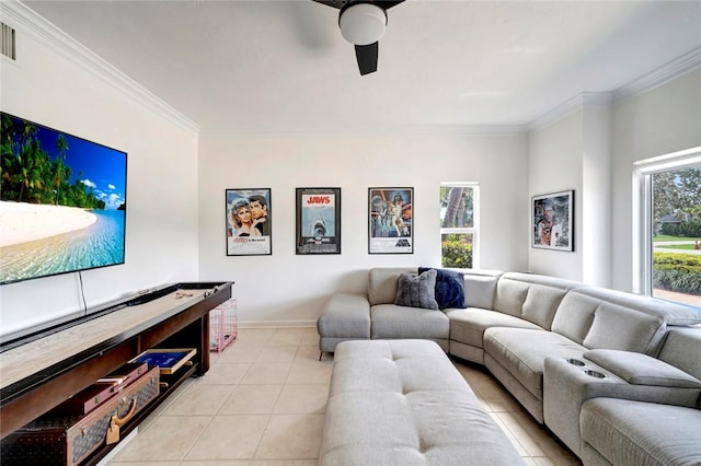 living area featuring light tile patterned flooring, baseboards, crown molding, and ceiling fan