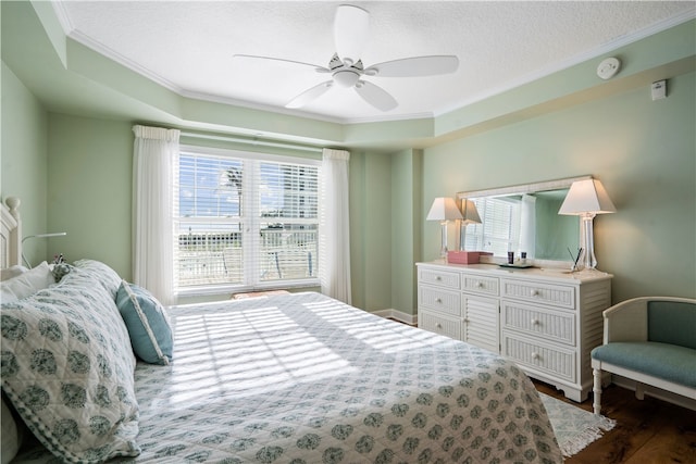 bedroom with dark wood-type flooring, ceiling fan, a textured ceiling, and ornamental molding