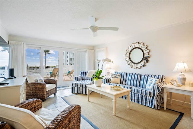 living room featuring a wealth of natural light, ceiling fan, a textured ceiling, and light tile patterned flooring