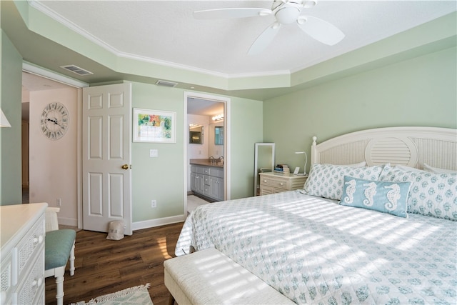 bedroom with dark hardwood / wood-style flooring, crown molding, ceiling fan, and ensuite bathroom