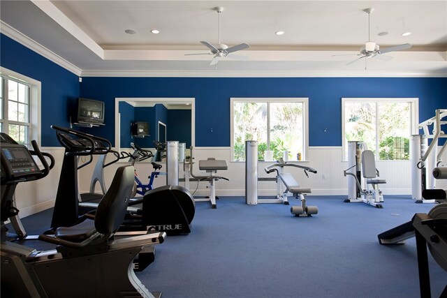 exercise room featuring ornamental molding, ceiling fan, and a healthy amount of sunlight