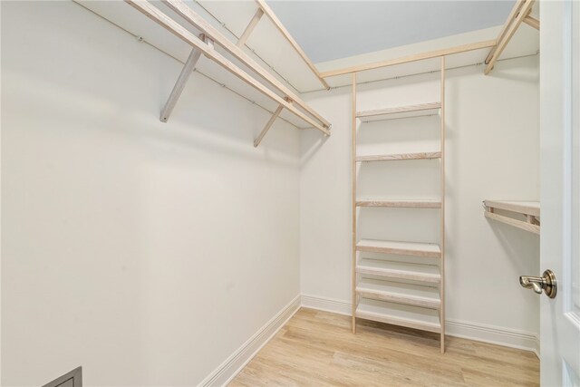 spacious closet featuring hardwood / wood-style floors